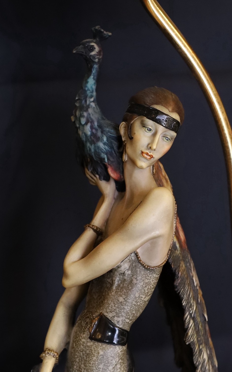 A 1980s Italian Giuseppe Armani lamp base, modelled with a resin lady holding a peacock, height 62cm, width of base 26cm